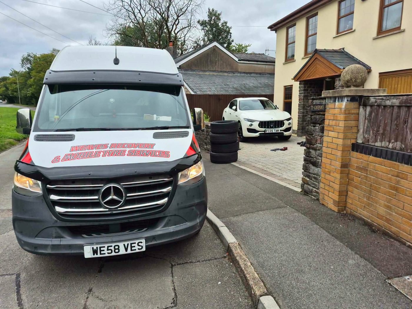 Weaves mobile tyre van fitting new tyres at a customer's home in South Wales